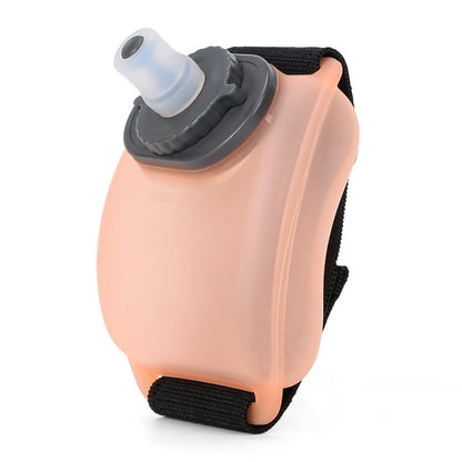 VeyaSports orange silicone wrist water bottle for running and cycling with a secure velcro strap and bite valve